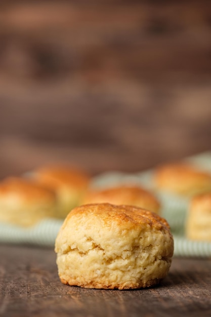 Group of scones on wood plate with jam on table