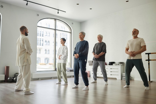 Group of senior people doing qigong exercise