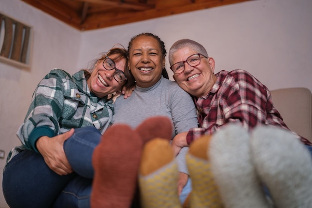 Group of senior women spending a winter evening by the fireplace Concept winter friendship socks