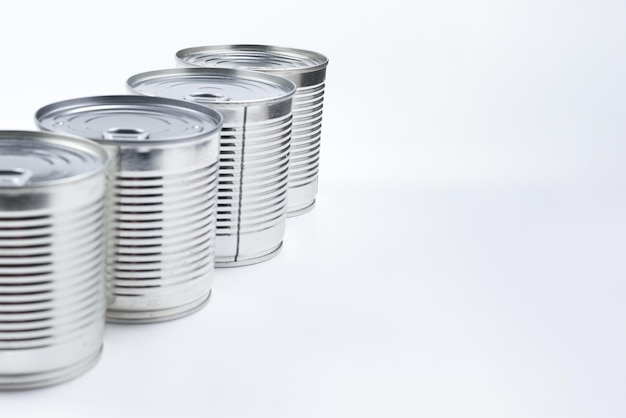 Group of silver canned food on white background