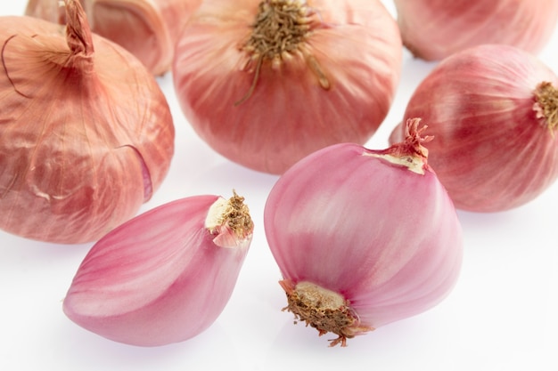 Group of small red shallot on white background