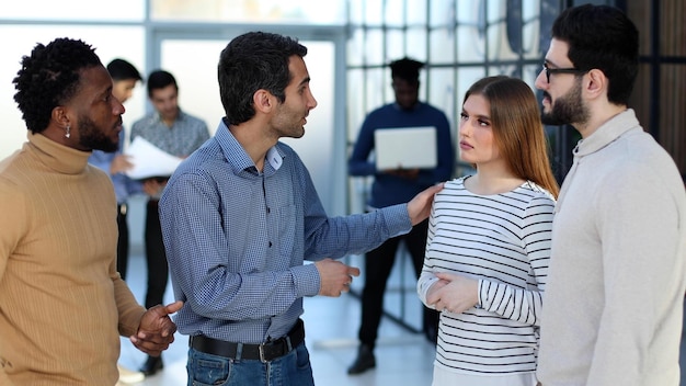 Group of smiling young business people discussing new ideas