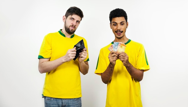 Group of soccer friends with Brazilian money isolated