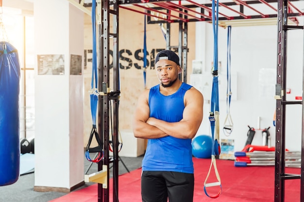 Group of sportive people in a gym training Multiracial group of athletes stretching before starting a workout session