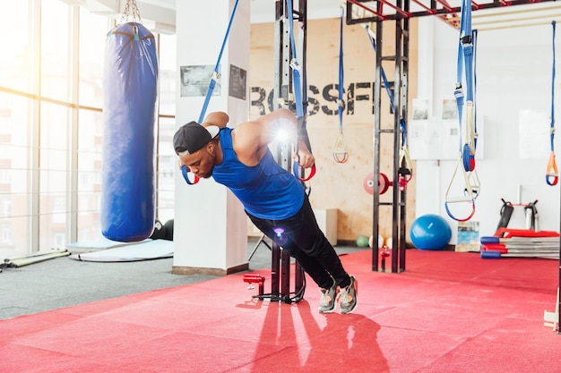 Group of sportive people in a gym training Multiracial group of athletes stretching before starting a workout session