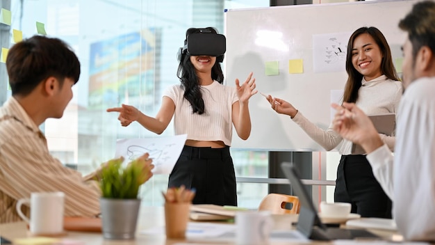 A group of startup having a meeting in the office wearing a VR headset