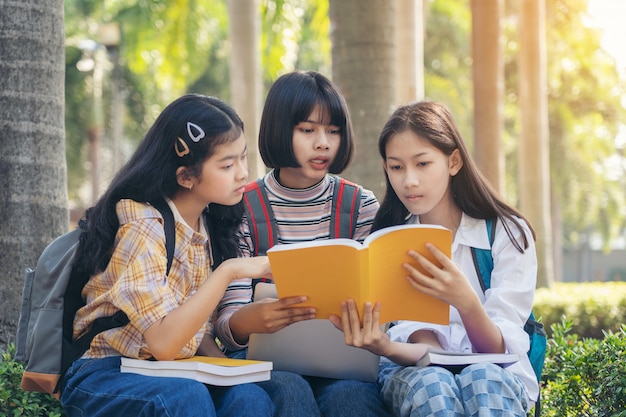 Group student young people and education reading book in city park