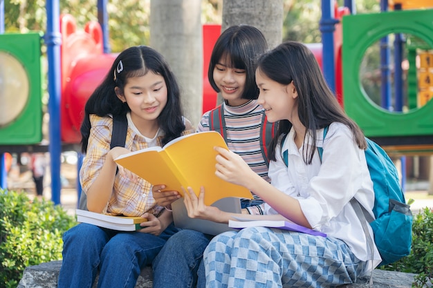 Group student young people and education reading book in city park