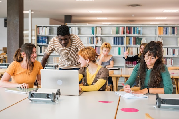 Group of students from different countries studying together in the university library