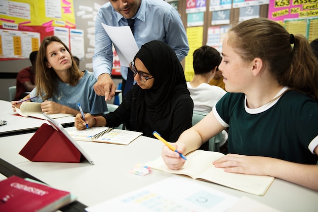 Group of students learning in classroom