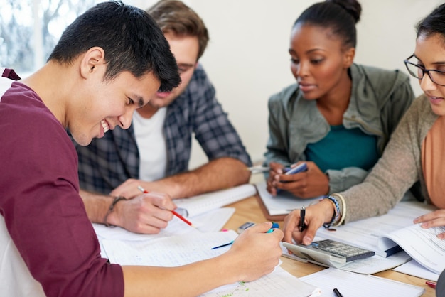 Group students and studying in college for education knowledge or test together University team and people reading book for information learning and help for math exam on calculator in class