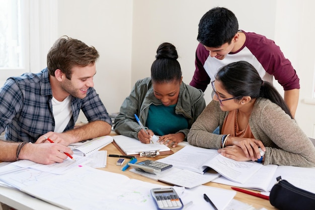 Group students and writing notes in university for learning knowledge or brainstorming together College friends and happy people study for information education and help for math exam in class