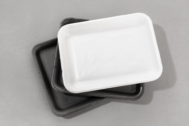 Group of styrofoam trays used for food Black and white Disposable polystyrene trays isolated on gray background