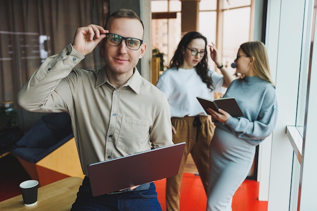 A group of successful business people are standing together in the office and talking to each other while working on starting a business in a modern working office Work in the office with colleagues