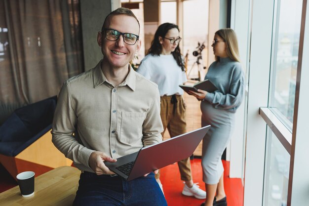 A group of successful business people are standing together in the office and talking to each other while working on starting a business in a modern working office Work in the office with colleagues