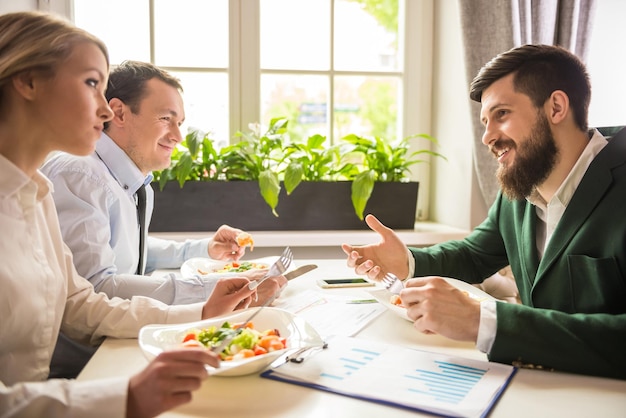 Group of successful business people at business lunch in cafe