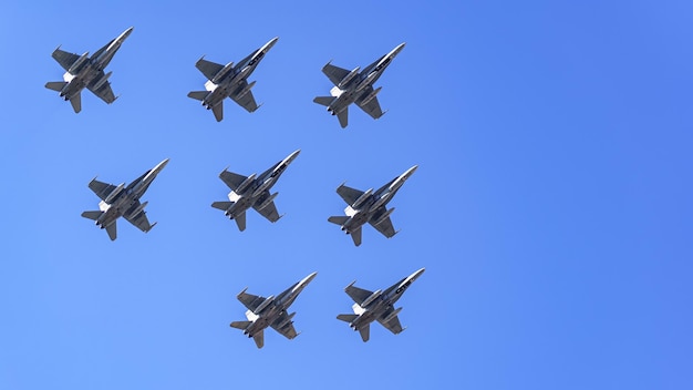 Group of supersonic aircraft in formation flying close together in an aerial military parade