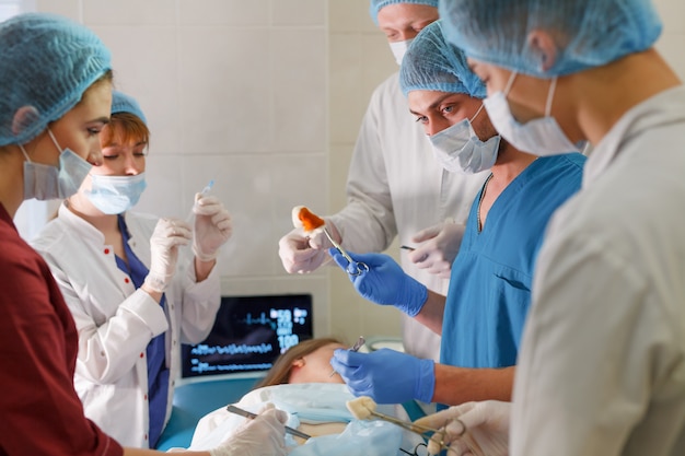 A group of surgeons doing operations in a hospital.