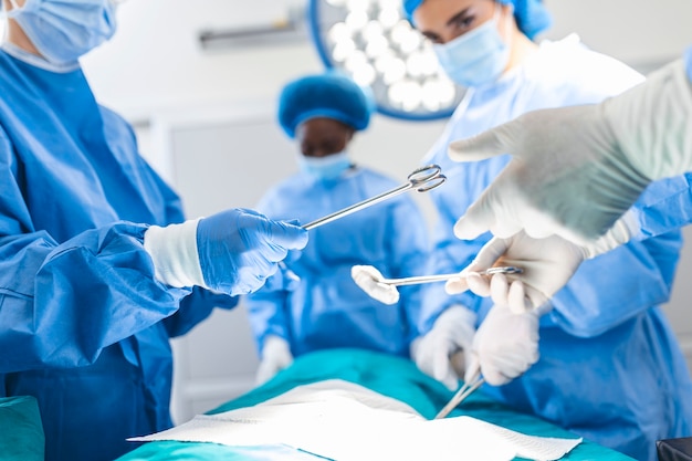 Group of surgeons in operating room with surgery equipment