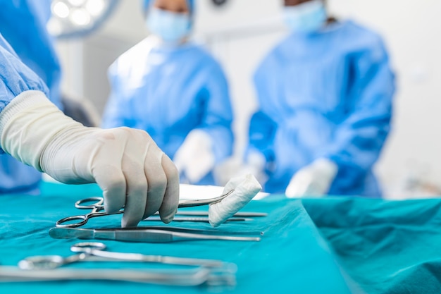 Group of surgeons in operating room with surgery equipment