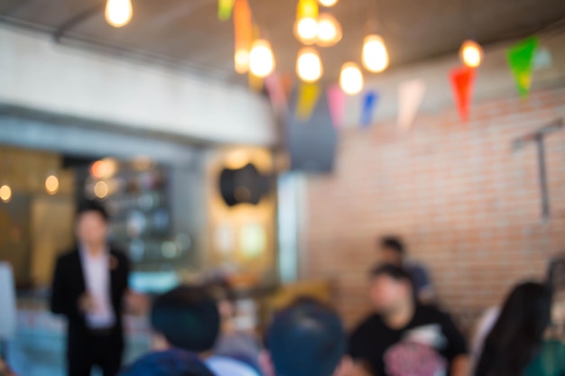 Group of teenagers in meeting at coffee shop Blur motion