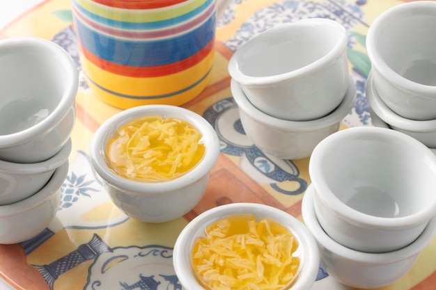 A group of thai jelly dessert with empty cups on plate