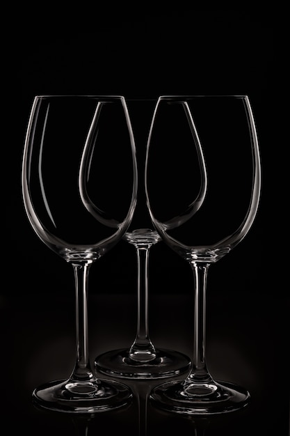 Group of three glass for wine on black