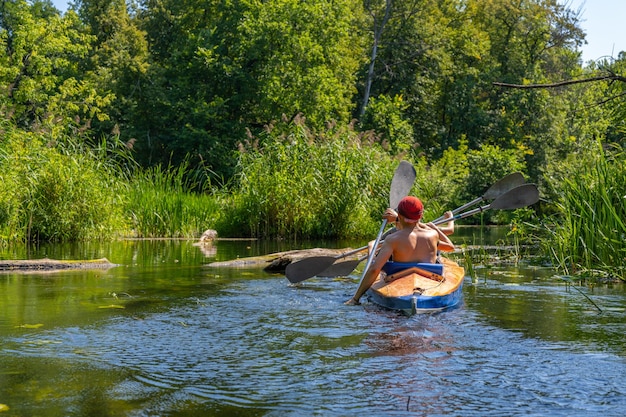 A group of three people paddle in a kayak Rafting on the fast river Adventure traveling lifestyle Concept wanderlust Active weekend vacations wild nature outdoor