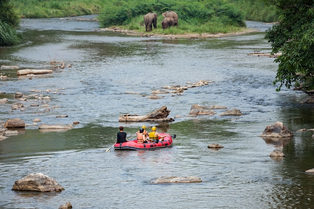 A group of tourists having fun on white water rafting in Mae Taeng river. Thailand.