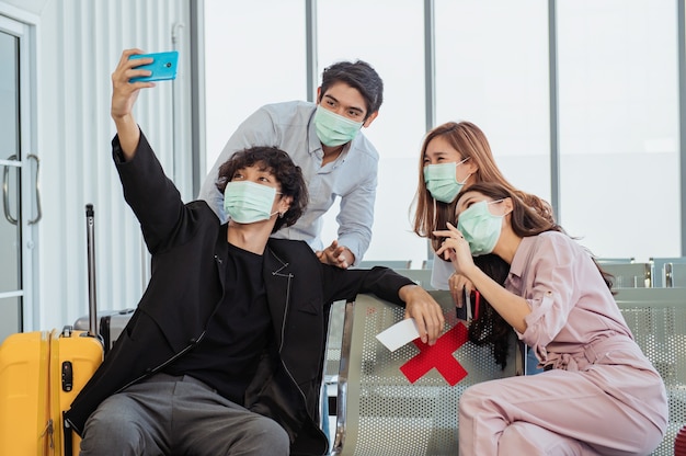 Group of tourists taking a selfie in the airport before their flight