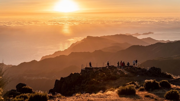 Group of tourists at the view point of Pico do Arieiro at sunset on Madeira, Portugal