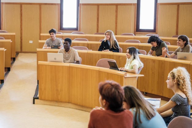 Group of university students in an amphitheatershaped classroom in a master class