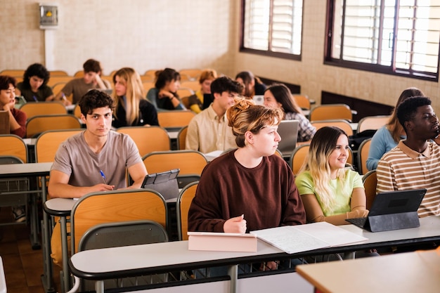 Group of university students in the classroom listening to the teacher39s explanations