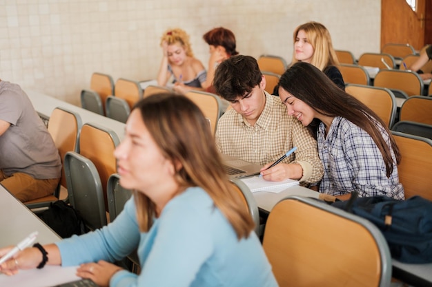 Group of university students in the classroom while the teacher gives the lesson