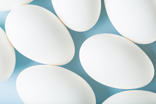 Group of white eggs on blue background