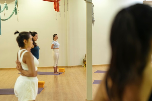 Group of women practicing Anjali mudra yoga pose