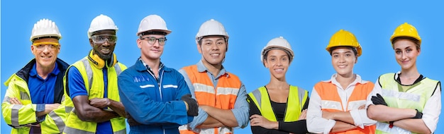 Group workers engineering standing with confident with blue working suite dress and helmet in front of blue background. Concept of smart industry worker operating. Diversity of people of industry.