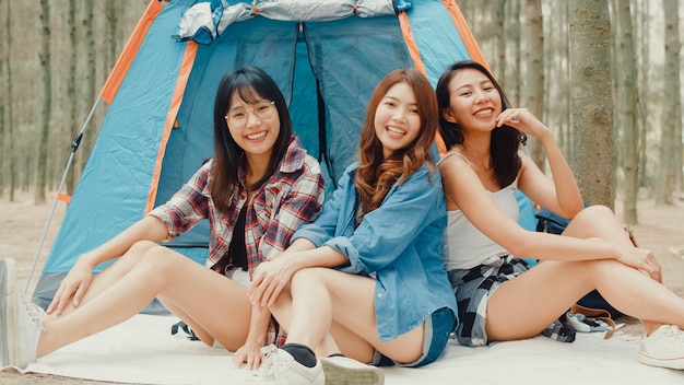 Group of young asia camper friends camping near relax enjoy moment in forest