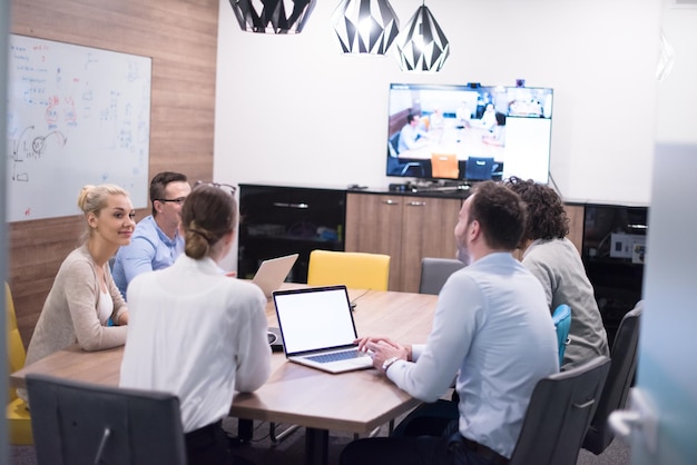 Group of a young business people discussing business plan at modern startup office building