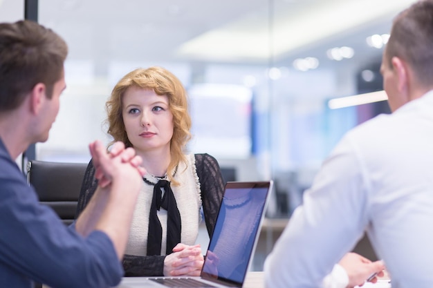 Group of a young business people discussing business plan at modern startup office building