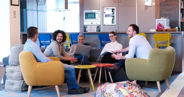 Group of a young business people discussing business plan at modern startup office building