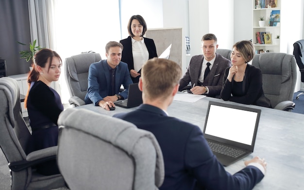 Group of young business people meeting in the office discussing an important idea together.