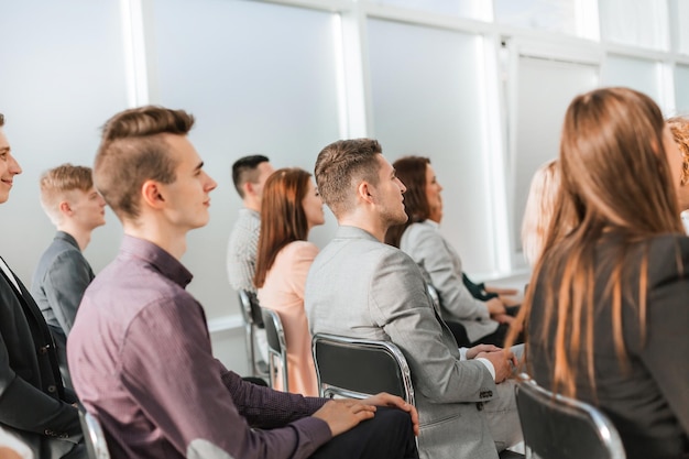 Group of young business people sitting in the conference room