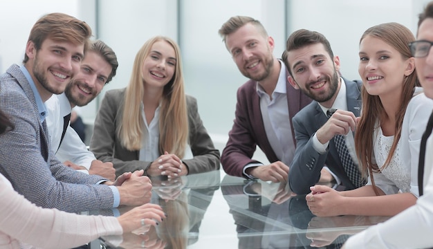 Group of young business people sitting at a table in a conference room