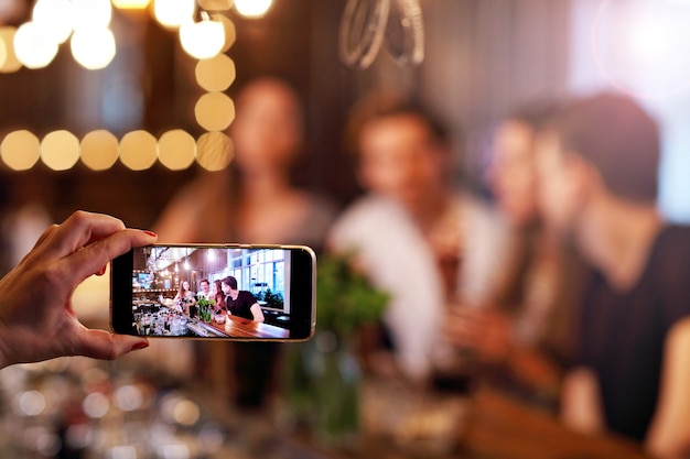 Group Of Young Friends Enjoying Meal In Restaurant