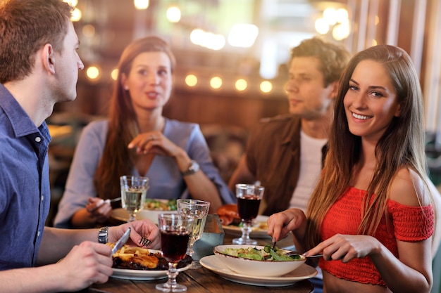 Group Of Young Friends Enjoying Meal In Restaurant