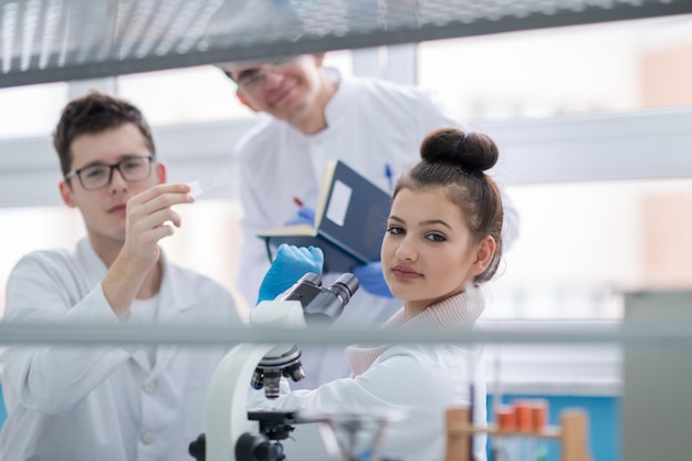 Group of young medical students doing research together in chemistry laboratory,teamwork by college student indoors