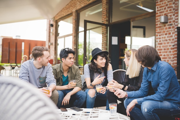 Group young multiethnic friends sitting bar having conversation