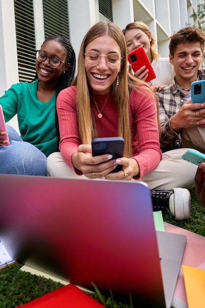 Group of young multiracial university students immersed on their mobile cell technology addicted