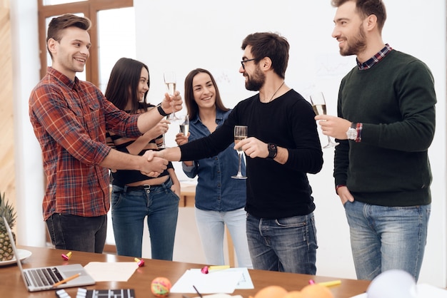 A group of young office workers celebrating.